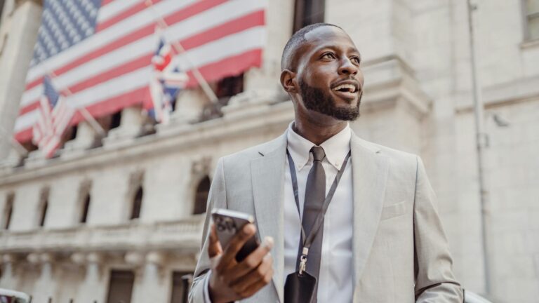 man standing in the street with a phone in his hand